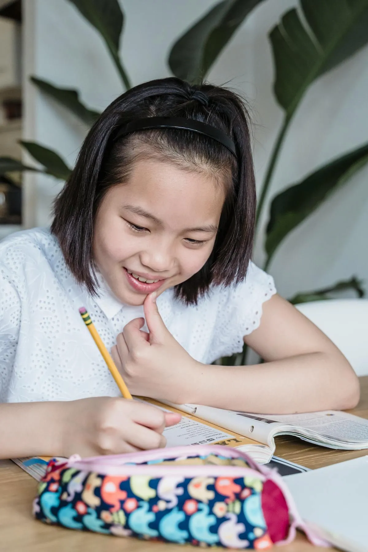 GCSE student studying with textbooks and notes at a desk